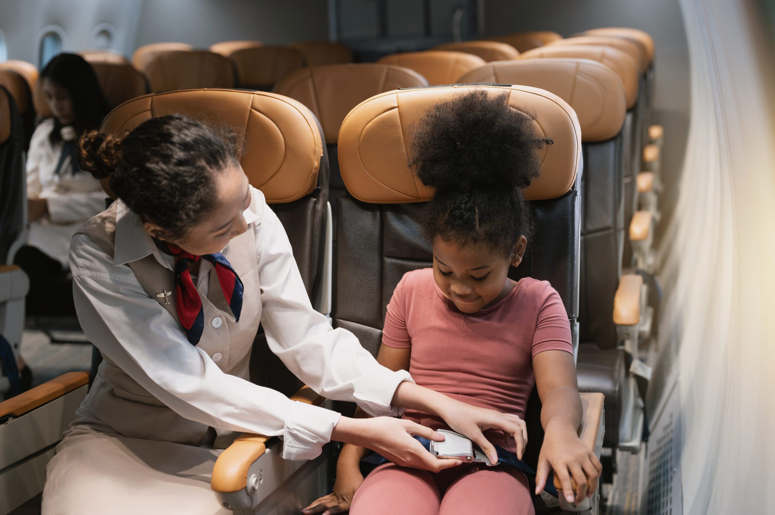 Flight attendant buckling a child into her seat